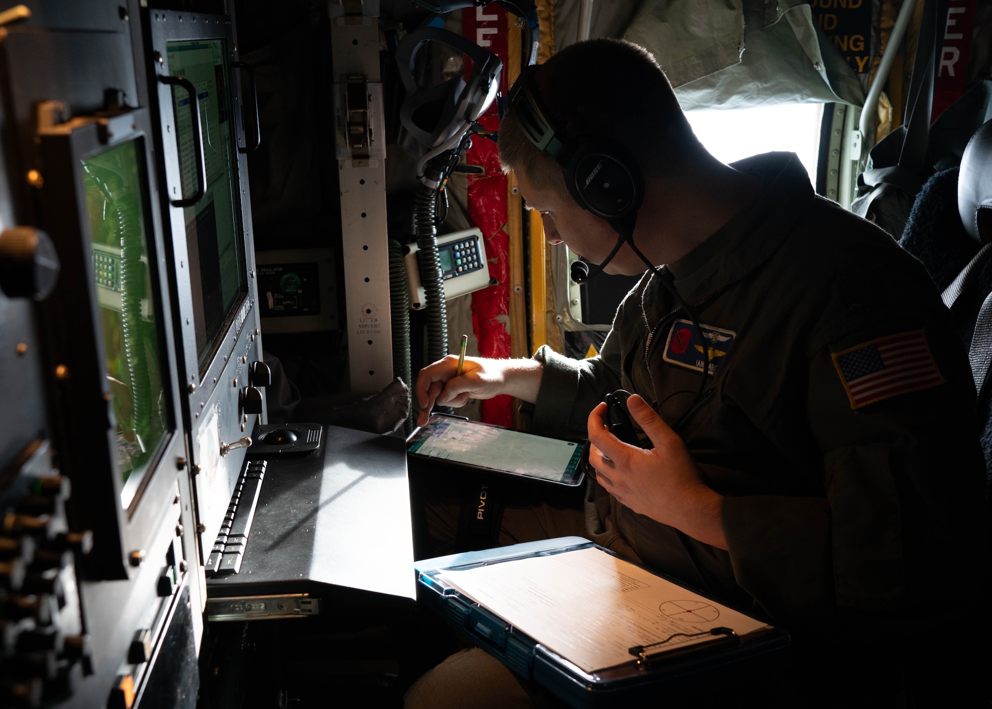 Air Force officer reviewing data and checklist in preparation for storm mission
