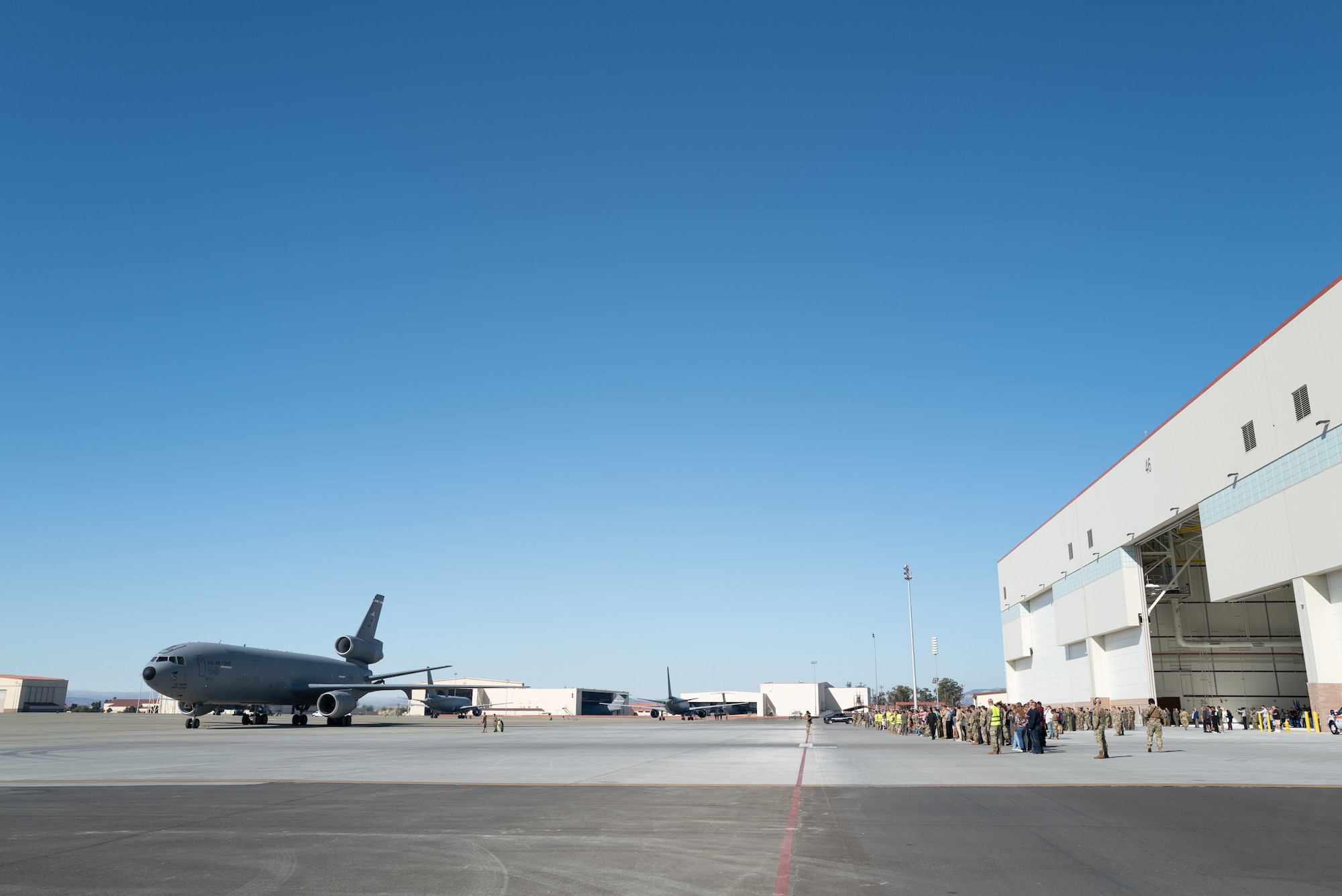 Guests observe aircraft taxing on flight line