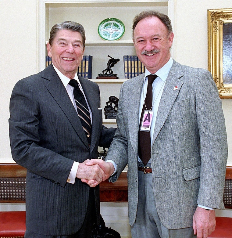 Two men shake hands.