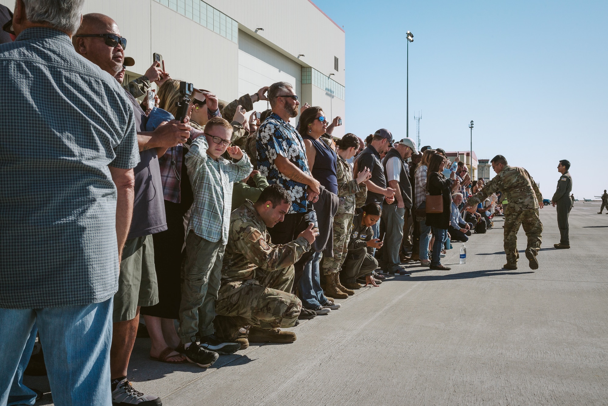Attendees watch aircraft prepare to take off.