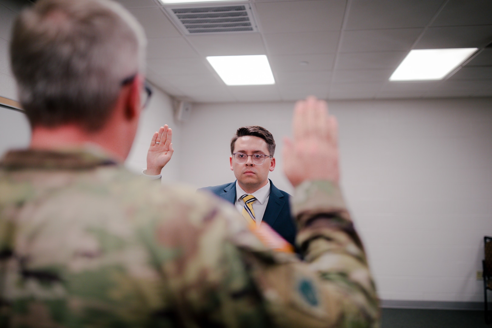 2nd Lt. Jesse Johnston takes the Oath of Commissioned Officers as a newly commissioned chaplain candidate in the Oklahoma Army National Guard during a commissioning ceremony in Oklahoma City, on Sept. 25, 2024. The mission of a chaplain is two-fold, impacting both individual Soldiers and overall mission readiness. This role includes providing religious support for Soldiers as well as advising the command on religious impacts of missions within the organization. (Oklahoma National Guard photo by Staff Sgt. Reece Heck)