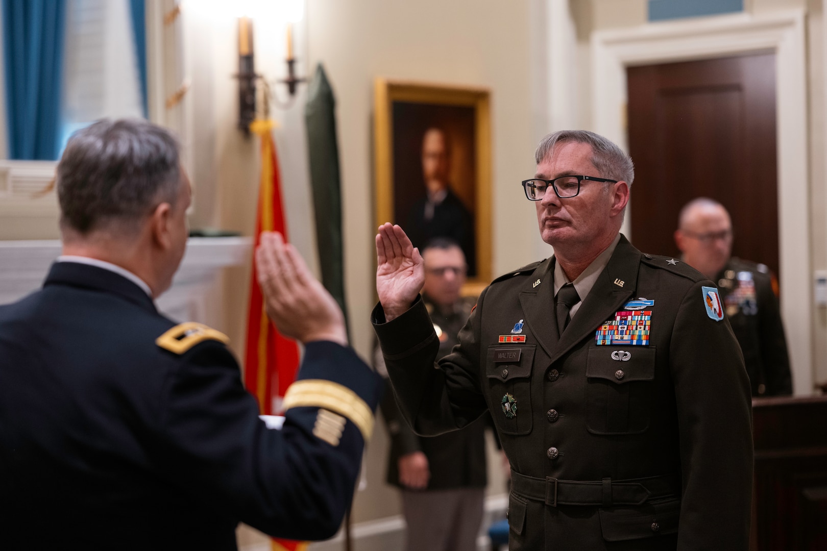 Brig. Gen. Robert Walter, assistant adjutant general - Army for the Oklahoma National Guard, raises his right hand during his oath of office at his promotion ceremony in the Blue Room at the Oklahoma Capitol on Sept. 26, 2024. Walter advises and assists the adjutant general in preparing Oklahoma Army National Guard units for domestic operations and mobilization. (Oklahoma National Guard photo by 1st Sgt. Mireille Merilice-Roberts)