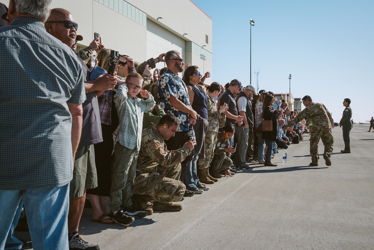Attendees watch aircraft prepare to take off.