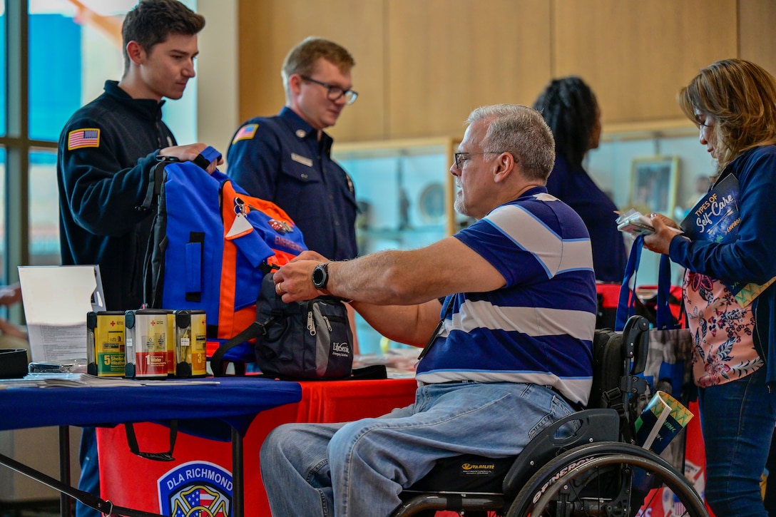 Attendees look at emergency kits.