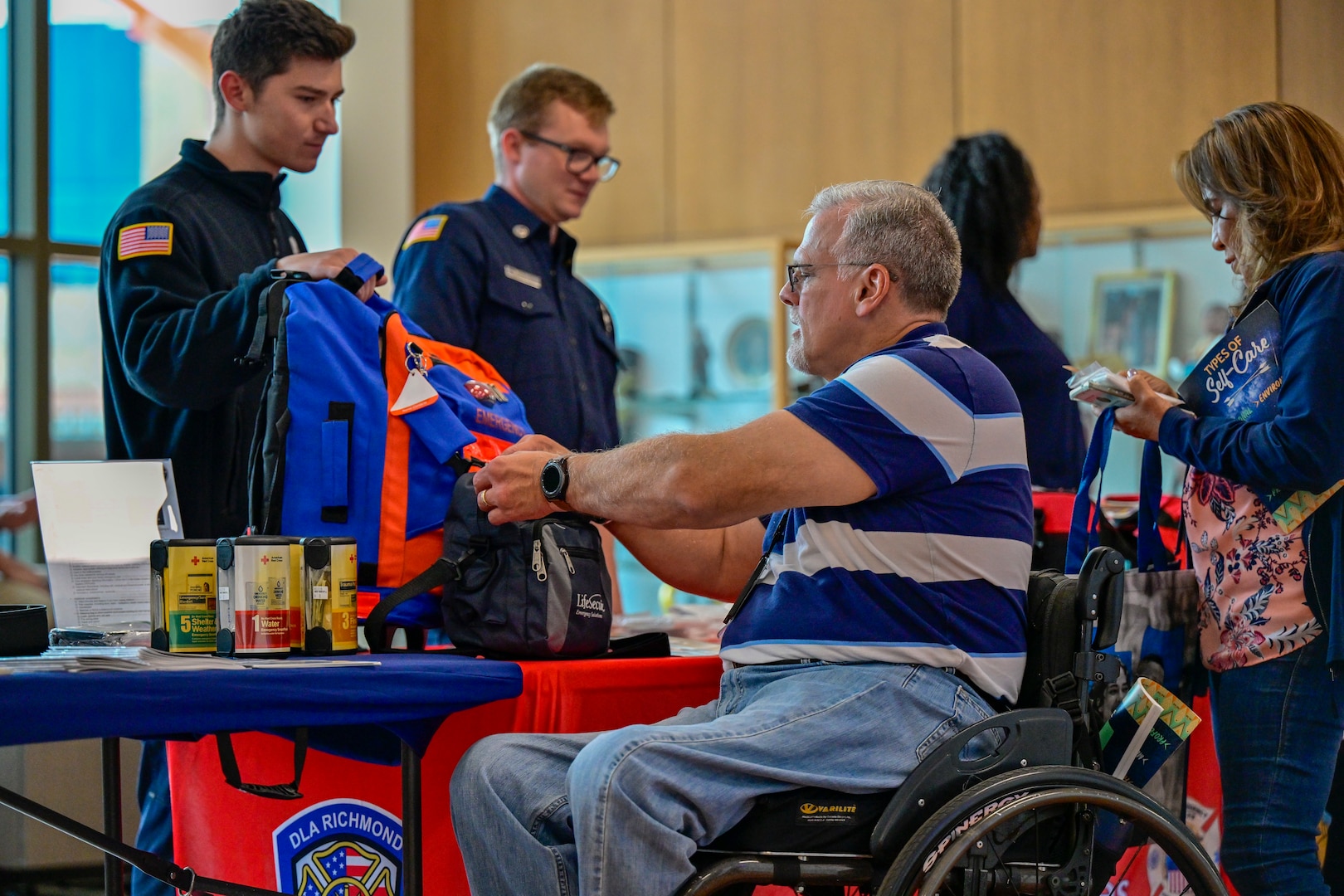 Attendees look at emergency kits.