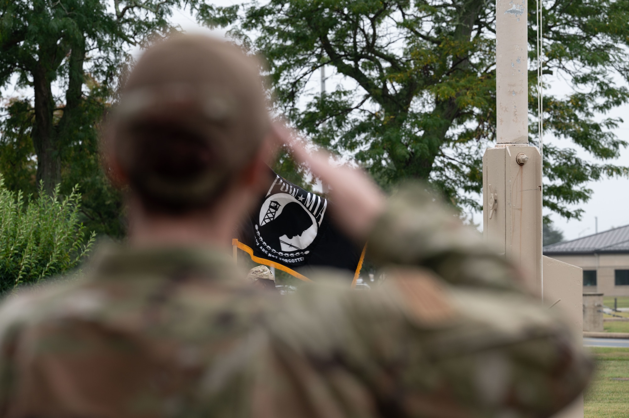 A Team Dover Airman salutes during taps at the POW/MIA Recognition Day retreat ceremony at Dover Air Force Base, Delaware, Sept. 27, 2024. In recognition of POW/MIA, Team Dover held a 24-hour ruck that was followed by a closing retreat ceremony, honoring all military personnel who have been taken captive and returned, as well as those who remain missing. (U.S. Air Force photo by Airman Liberty Matthews)