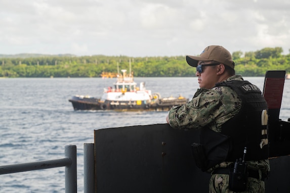 U.S. Navy Master-at-Arms 2nd Class Jeriel Galgo, from Cavite, Philippines, stands watch aboard the Nimitz-class aircraft carrier USS Theodore Roosevelt (CVN 71) as the ship departs Apra Harbor, Guam, Sept. 26, 2024.