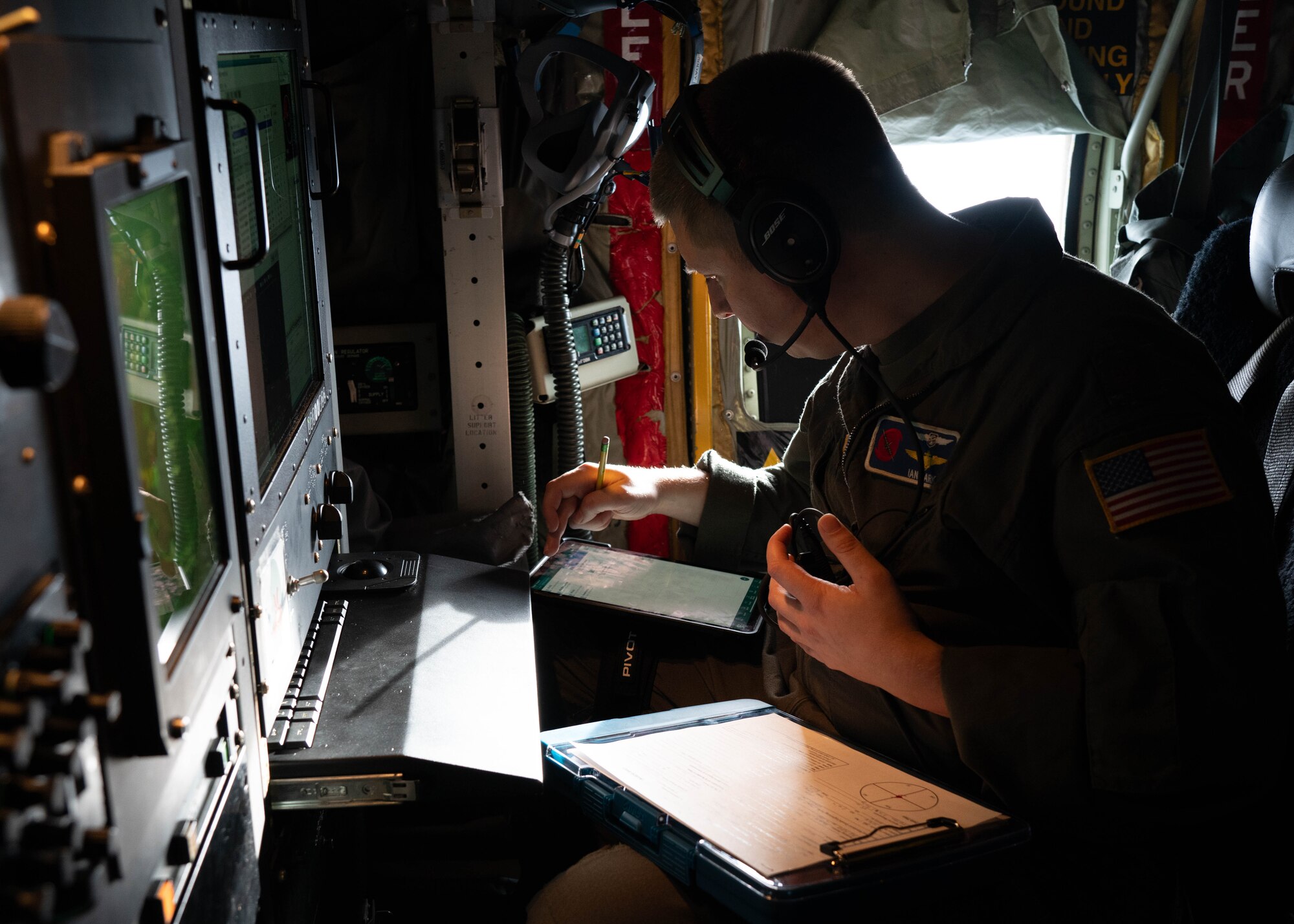 Air Force officer reviewing data and checklist in preparation for storm mission