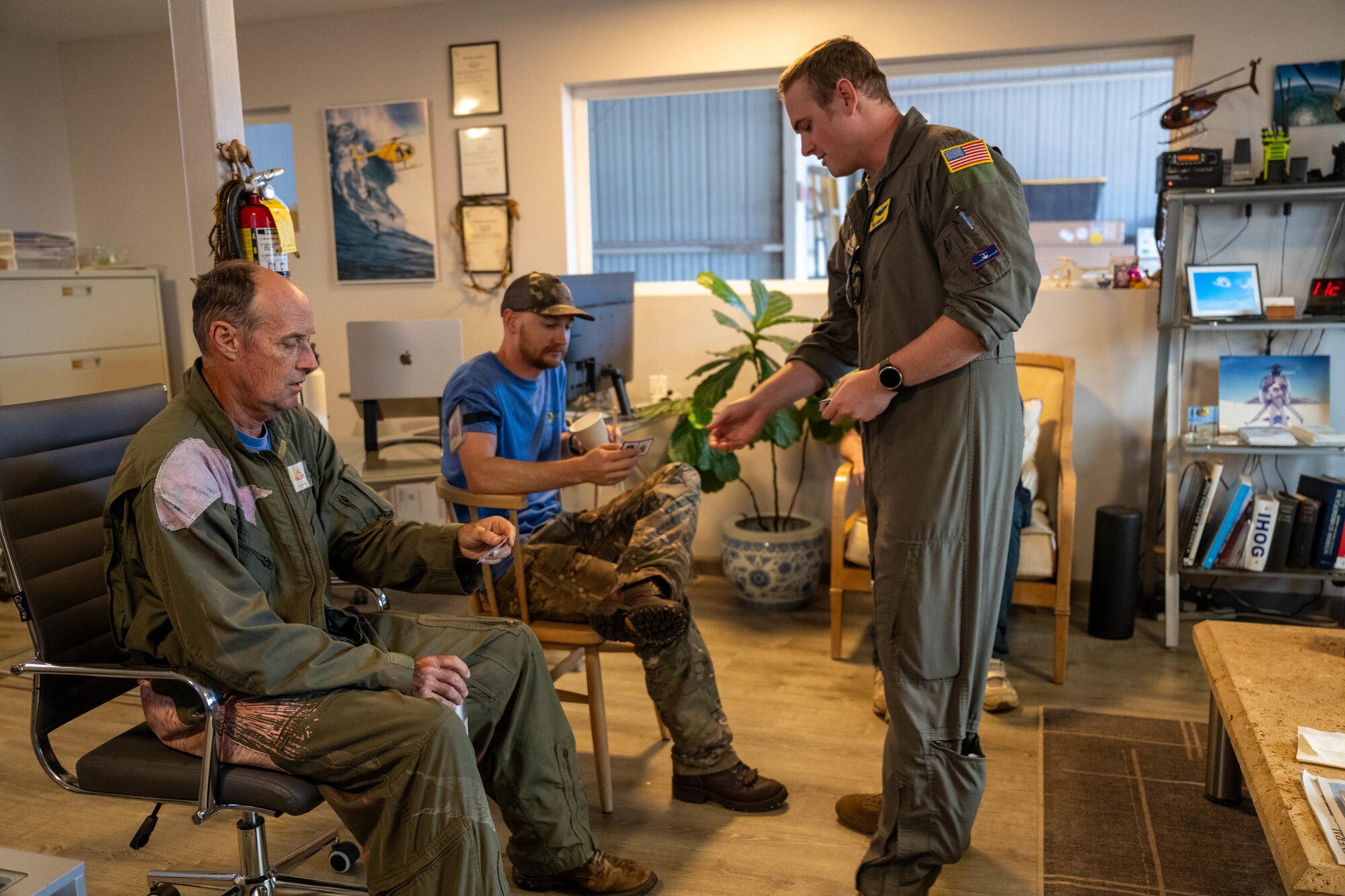 U.S. Air Force Maj. Rich Gangloff, 15th Wing Safety officer, hands business cards to a local aviation academy’s helicopter team on Maui, Hawaii, Sept. 26, 2024. The 15th Wing Safety Office aims to build new connections within general aviation communities across the Hawaiian Islands.  (U.S. Air Force photo by Airman 1st Class Aden Brown)