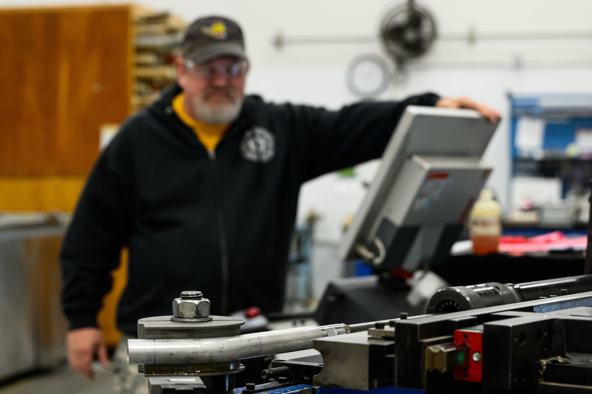 A man uses a pipe bending machine