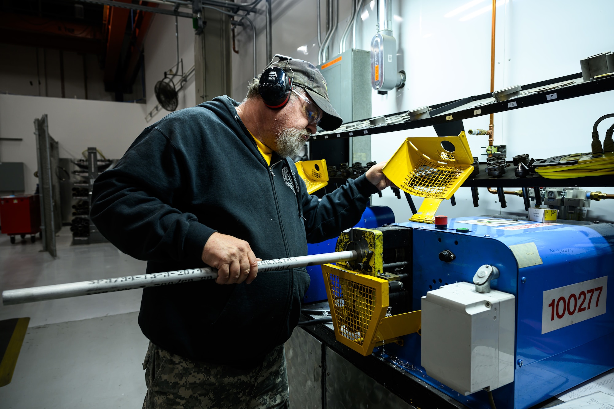 A man uses machenery to bend pipe