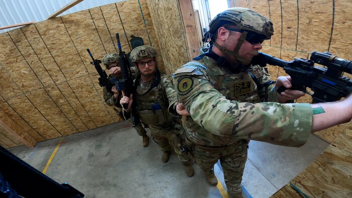 defenders standing with guns