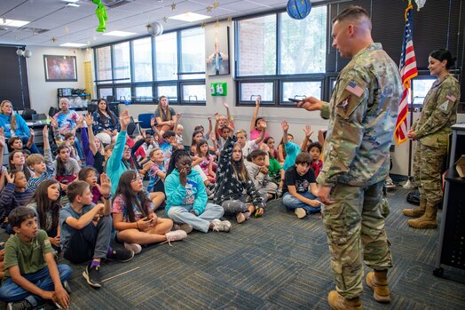  Two servicemembers brief classroom of fifth grade students