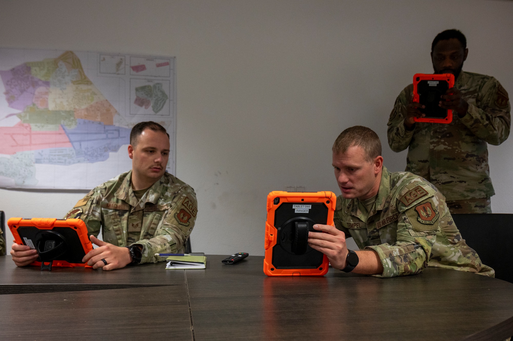 U.S. Air Force Staff Sgt. Zachary Mitchell, 86th Maintenance Squadron aerospace ground equipment noncommissioned officer in charge of dispatch, and U.S. Air Force Tech. Sgt. Alexander Tempel, 86th MXS AGE section chief, discuss the RANGER AGE Management System’s capabilities at Ramstein Air Base, Germany, Sept. 24, 2024.