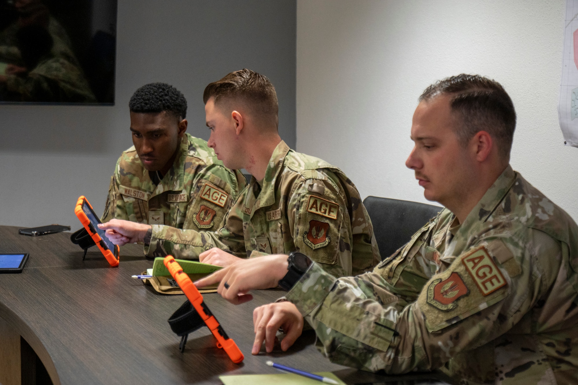 U.S. Air Force Airman First Class Javiyon Walston, 86th Maintenance Squadron aerospace ground equipment apprentice, U.S. Air Force Senior Airman Christian Governale, 86th MXS AGE journeyman, and U.S. Air Force Staff Sgt. Zachary Mitchell, 86th MXS AGE noncommissioned officer in charge of dispatch, explore the RANGER AGE Management System’s user interface at Ramstein Air Base, Germany, Sept. 24, 2024.