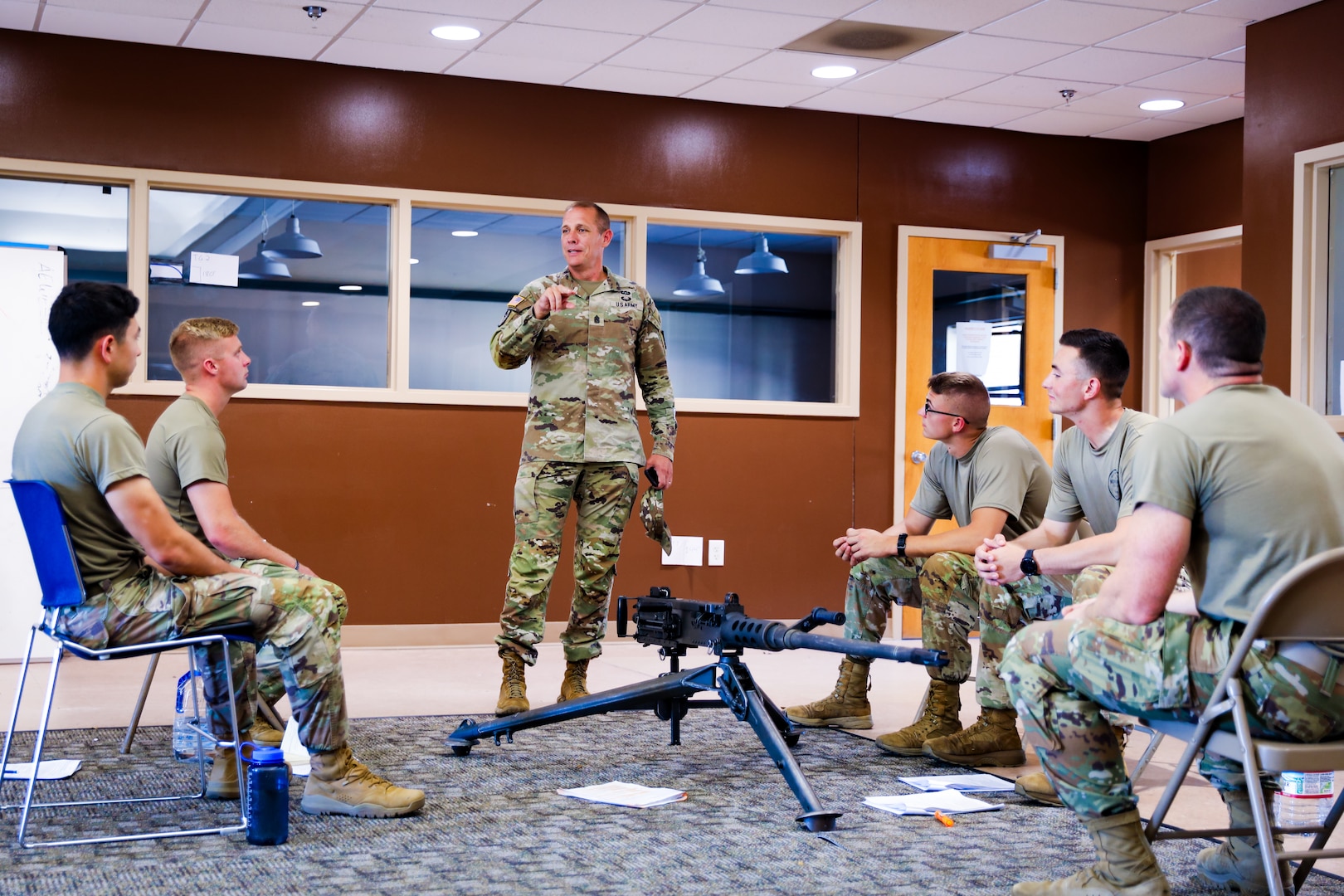 Command Sgt. Maj. John T. Raines, the 13th Army National Guard command sergeant major, talks with the 2024 Best Squad competitors as they prepare for this year's competition in Fort Moore, Ga. Sept. 24, 2023. The team practices weapons function checks training for the 2024 All-Army Best Squad Competition.