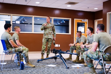 Command Sgt. Maj. John T. Raines, the 13th Army National Guard command sergeant major, talks with the 2024 Best Squad competitors as they prepare for this year's competition in Fort Moore, Ga. Sept. 24, 2023. The team practices weapons function checks training for the 2024 All-Army Best Squad Competition.