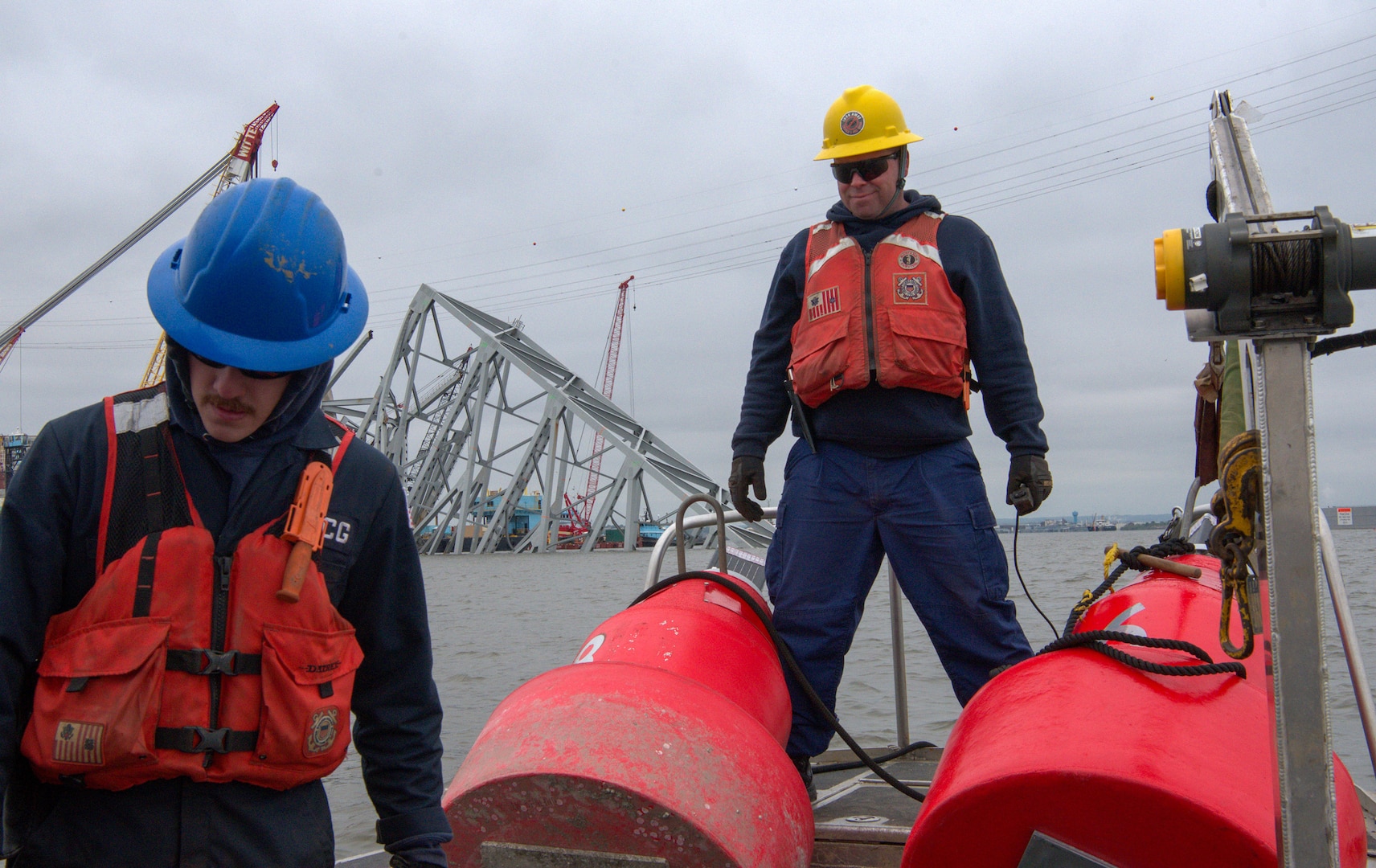 Petty Officer 1st Class Anthony Tartaglia, a machinery technician from U.S. Coast Guard Sector Maryland - National Capital Region, assists with the deployment of federal aids to navigation marking the Fort Carroll Temporary Alternate Channel on April 19, 2024. The Key Bridge Response is one of the operational missions that will qualify for special leave accrual (SLA) in FY 24.