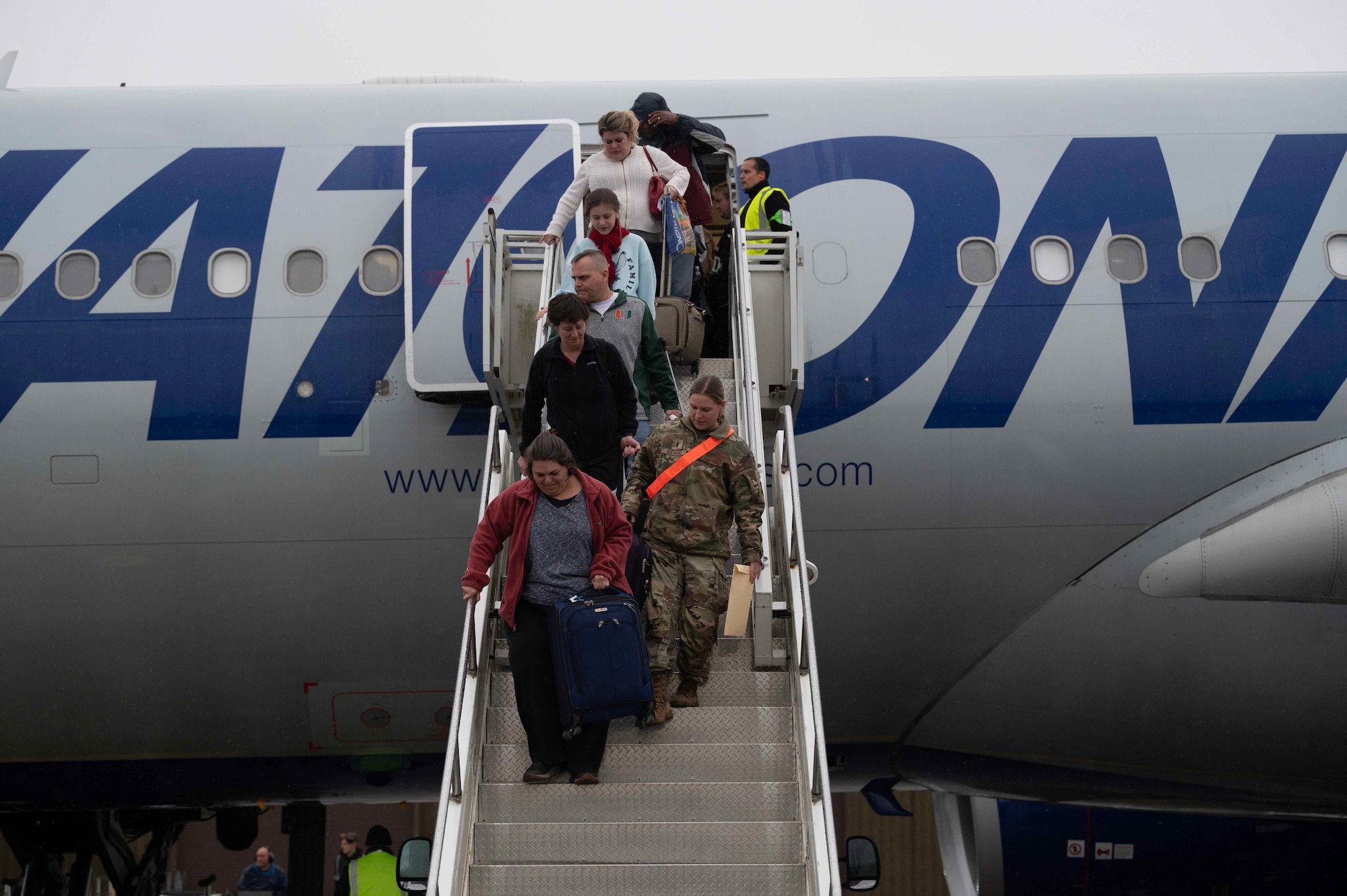 Passengers exit a plane
