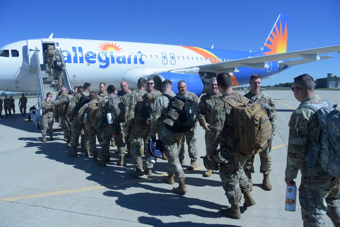 More than 300 Wisconsin Army National Guard Soldiers from five units board charter flights Sept. 28 at Volk Field Air National Guard Base, Camp Douglas, Wis., following a formal sendoff ceremony. The Soldiers, who are a part of the 1st Battalion, 128th Infantry Regiment, the 1st Battalion, 120th Field Artillery Regiment, the 132nd Brigade Support Battalion and the 457th Chemical Company, will be deploying to both U.S. Central Command in Southwest Asia and U.S. Africa Command, Horn of Africa. The deploying Soldiers will support ongoing operations through tactical missions, and provide medical care capabilities across the region. Wisconsin Department of Military Affairs photo by Vaughn R. Larson