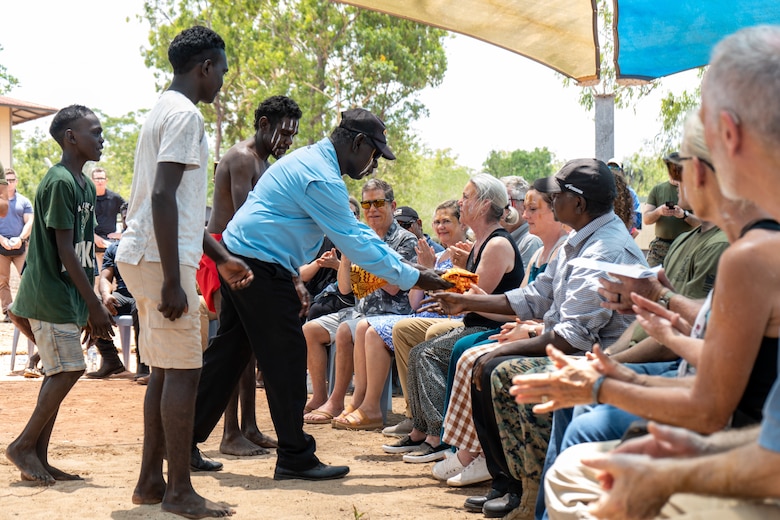 Tiwi Island-Mantiyupwi clan members give gifts to families of three fallen U.S. Marines during a Pukumani ceremony hosted by the Tiwi Island-Mantiyupwi clan, in collaboration with the Larrakia Nation Aboriginal Corporation, at Melville Island, Tiwi Islands, Australia, Sept. 27, 2024. The Pukumani Ceremony is a traditional Tiwi people ritual that honors the deceased and helps guide their spirits to the afterlife, marking the official end of mourning. For the first time, U.S. Marines and family members of the fallen were honored by the Tiwi and Larrakia people during the week leading up to two culturally significant ceremonies: a healing ceremony and a Pukumani ceremony. These ceremonies commemorated the three U.S. Marines who tragically lost their lives in a U.S. Marine Corps MV-22B Osprey crash on Melville Island on Aug. 27, 2023. (U.S. Marine Corps photo by Gunnery Sgt. Kassie McDole)
