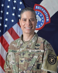 Female Soldier in front of United States and Army Recruiting Brigade flags