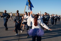 Members of Team Minot encourage runners during a base-wide two-mile run at Minot Air Force Base, North Dakota, Sept. 27, 2024. This event was part of a day focused on suicide prevention and resiliency. (U.S. Air Force photo by Airman 1st Class Luis Gomez)