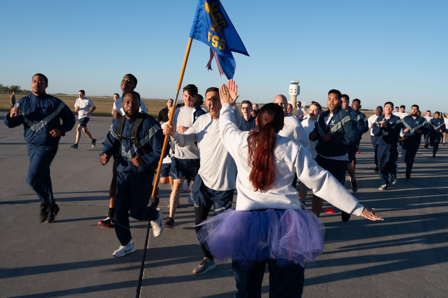 Members of Team Minot encourage runners during a base-wide two-mile run at Minot Air Force Base, North Dakota, Sept. 27, 2024. This event was part of a day focused on suicide prevention and resiliency. (U.S. Air Force photo by Airman 1st Class Luis Gomez)