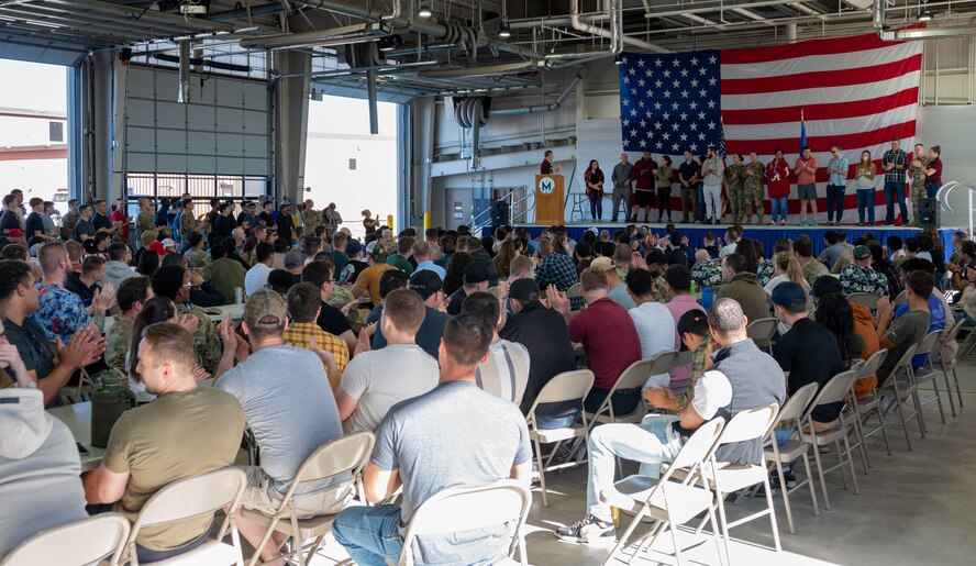 U.S. Air Force Col. James Schlabach, 91st Missile Wing (91 MW) commander, highlights organizations at Team Minot that foster resiliency during an all-call at Minot Air Force Base, North Dakota, Sept. 27, 2024. The 91 MW spent the day focusing on resiliency starting with a two-mile run, followed by an all-call and training sessions on mental health support by focusing on a community where no one fights alone. (U.S. Air Force photo by Airman 1st Class Luis Gomez)