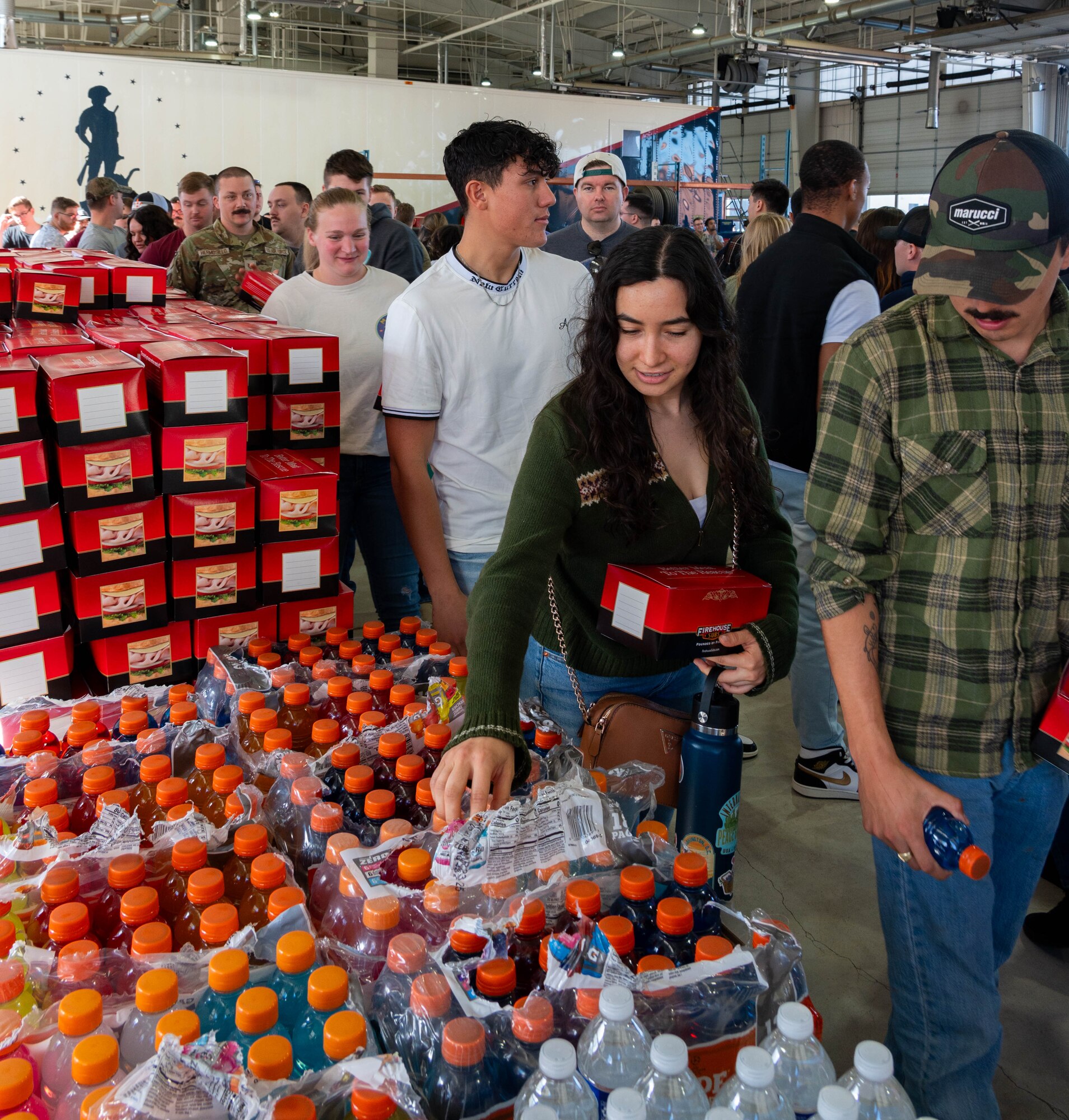 Airmen assigned to the 91st Missile Wing (91 MW) grab lunch provided by True North after the all-call at Minot Air Force Base, North Dakota, Sept. 27, 2024. The 91 MW spent the day focusing on resiliency starting with a two-mile run, an all-call and training sessions on mental health support and fostering a community where no one fights alone. (U.S. Air Force photo by Airman 1st Class Luis Gomez)