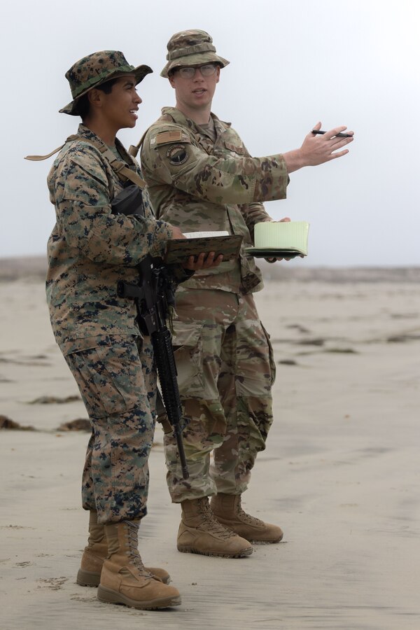 U.S. Marine Corps Sgt. Sabrina Melendezvillalvir, left, a Meteorological and Oceanographic Analyst Forecaster with METOC Platoon, 1st Intelligence Battalion, I Marine Expeditionary Force Information Group, conducts near shore forecasting with U.S. Air Force Staff Sgt. Jace Harter, a staff weather officer, *Command*, during Cobra Horizon 24.2 at Marine Corps Base Camp Pendleton, California, Sept. 25, 2024. Cobra Horizon is an inter-service exercise that rehearses METOC employment and familiarizes Marines and Airmen with the rapid response planning process in preparation for future I MEF operations. (U.S. Marine Corps photo by Lance Cpl. Nicole Stuart)
