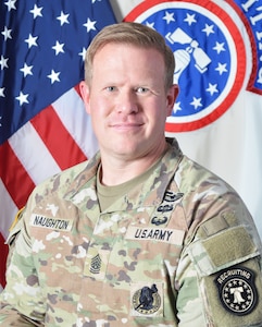 Army Soldier in front of U.S. and Army Recruiting Flags