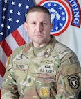 Army Soldier in front of U.S. and Army Recruiting flags