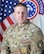 Army Soldier in front of U.S. and Army Recruiting flags