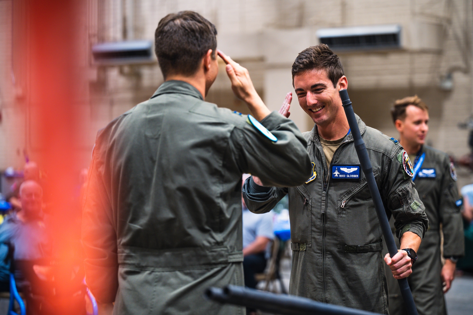U.S. Air Force Capt. Reed Glosser (right), 309th Fighter Squadron graduate pilot, salutes Capt. Nick Belinski (left), 309th Fighter Squadron instructor pilot during the final 309th FS graduation for F-16 Fighting Falcon pilots.