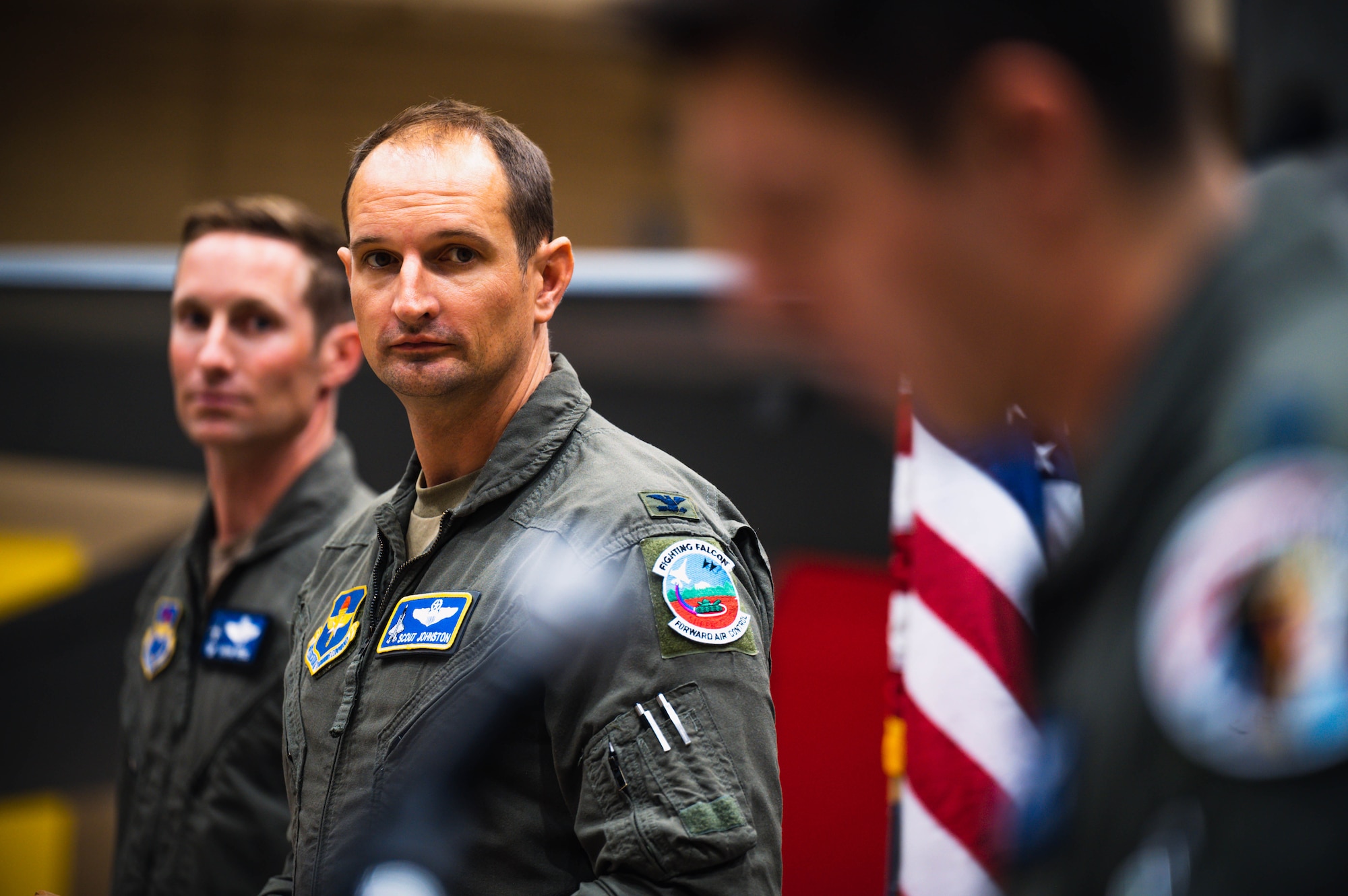 U.S. Air Force Col. Matthew Johnston (center), 56th Fighter Wing deputy commander, looks to U.S. Air Force Capt. Nick Belinski (right), 309th Fighter Squadron instructor pilot, during the final 309th FS graduation for F-16 Fighting Falcon pilots.