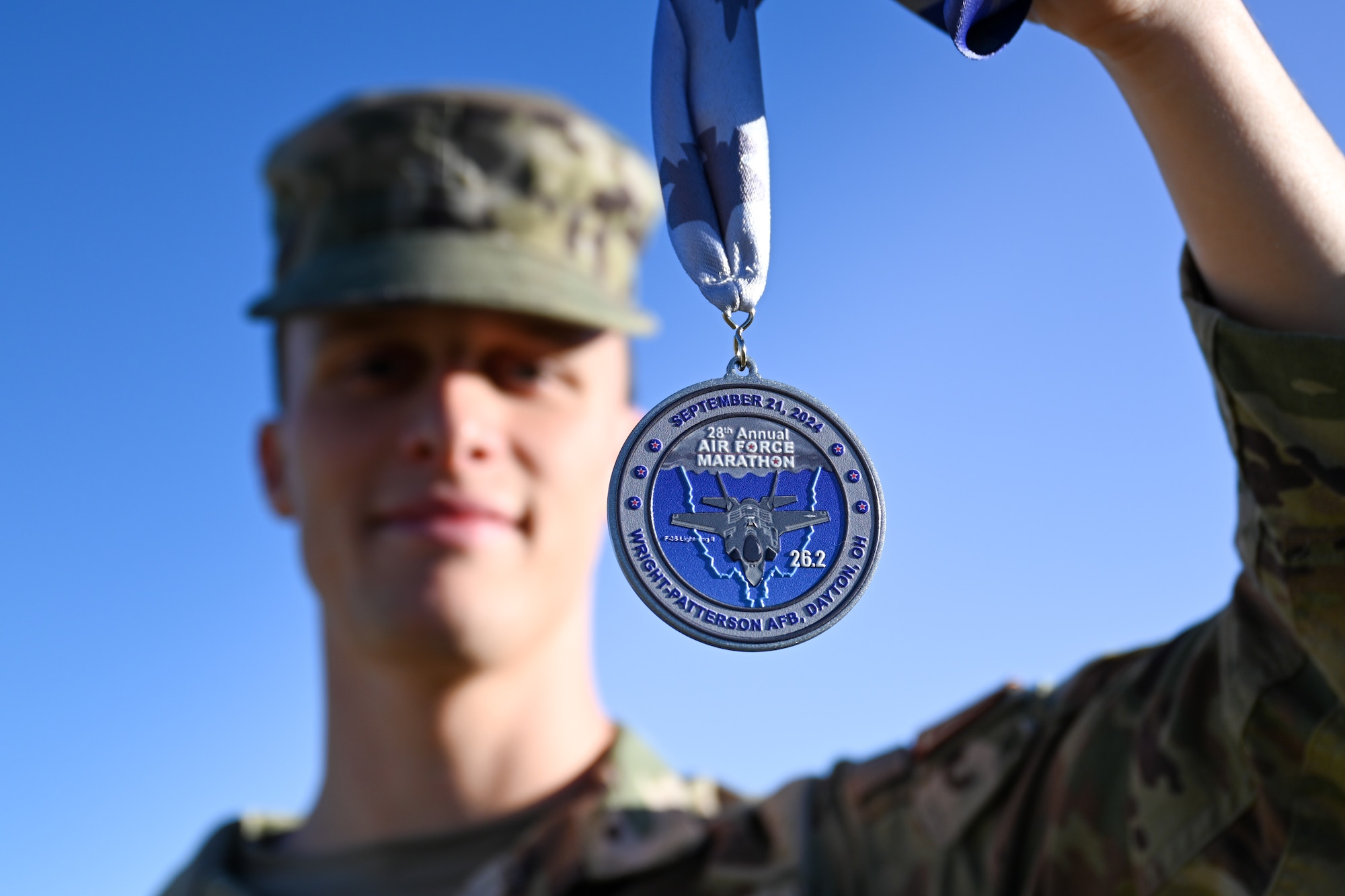 U.S. Air Force Airman 1st Class Jonah Bliss, 97th Air Mobility Wing public affairs apprentice, poses with his 2024 Air Force Marathon medal at Altus Air Force Base, Oklahoma, Sept. 30, 2024. Bliss trained for this marathon for 18 weeks along with other members of Mobility’s Hometown Run Club. (U.S. Air Force photo by Staff Sgt. Cody Dowell)