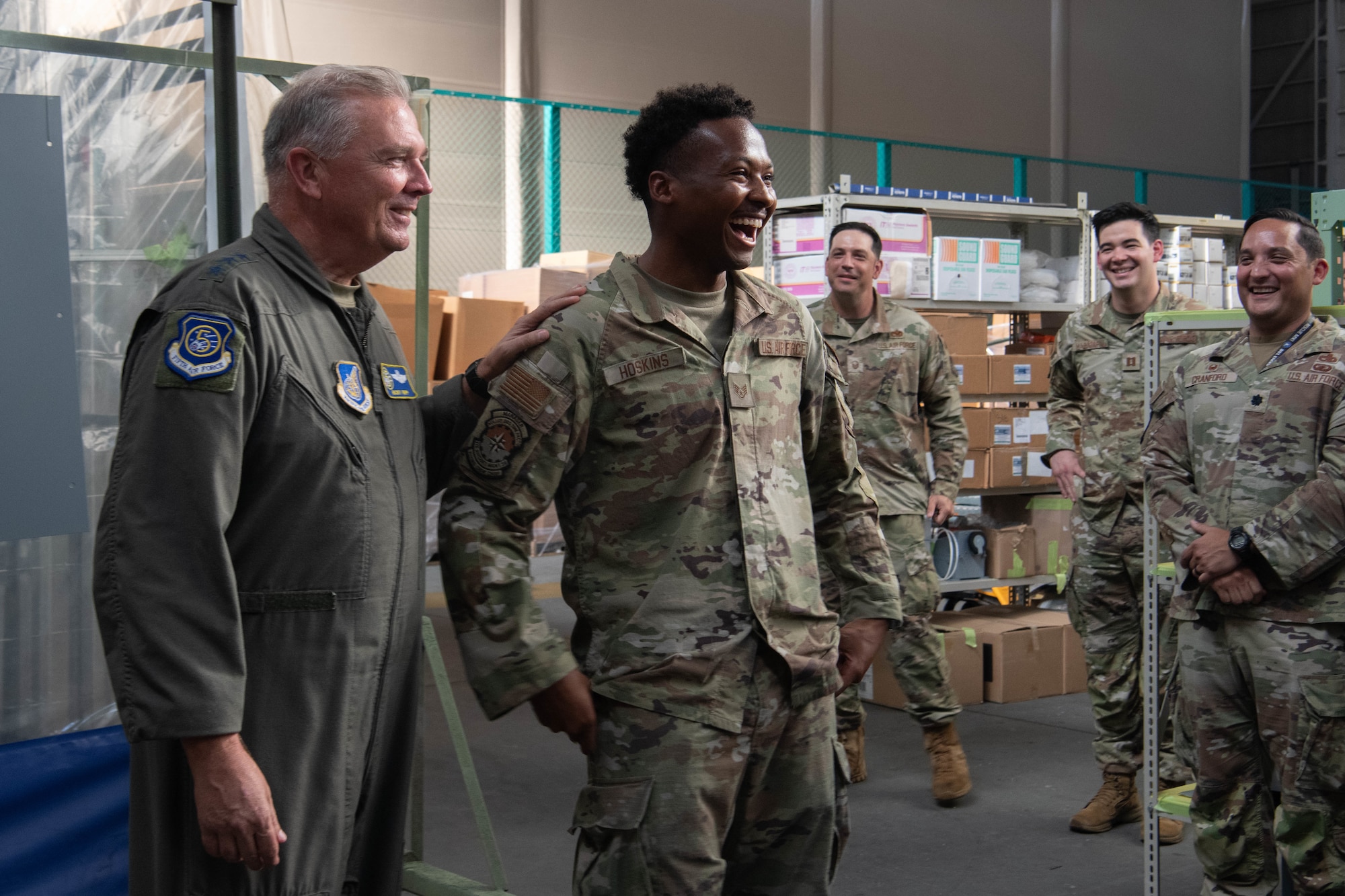 U.S. Air Force Lt. Gen. Ricky Rupp, U.S. Forces Japan and 5th Air Force commander, and Staff Sgt. Ameer Hoskins, 374th Aircraft Maintenance Squadron flying crew chief manager, celebrate after a coining.