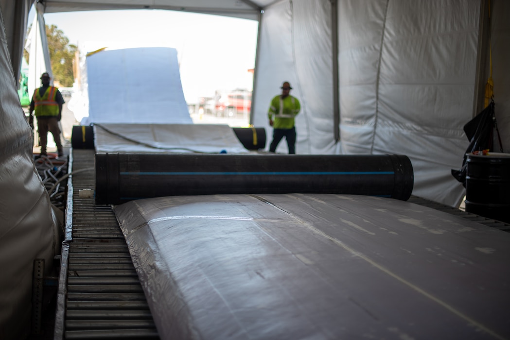 workers unroll liner for temporary lake