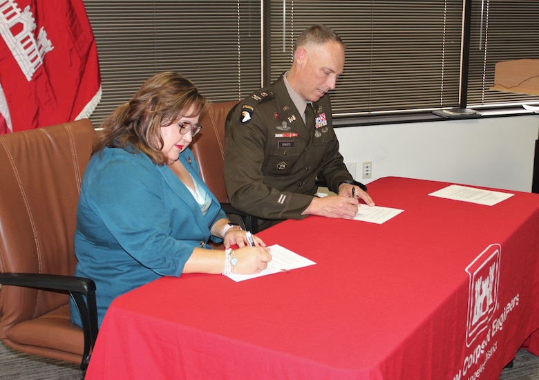 Mila Besich, mayor of the City of Superior, left, and Col. Andrew Baker, U.S. Army Corps of Engineers Los Angeles District commander, right, sign a project partnership agreement under the Section 595 Program Sept. 16 in Phoenix. Projects under the 595 Program may include wastewater treatment and related facilities, water supply and related facilities, environmental restoration, and surface water resource protection and development.  USACE can engage in design, construction or both for projects under this program.