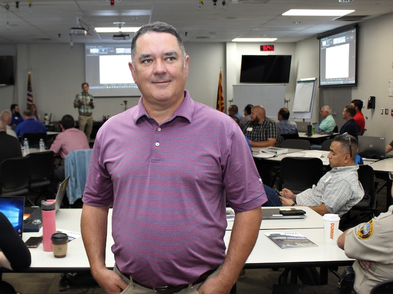 Los Angeles District Dam Safety Program Manager Kyle Hayworth poses for a picture after presenting the flood history of Painted Rock Dam during a tabletop exercise Sept. 18 at Yuma Public Works in Yuma, Arizona. The exercise increases the coordination and preparation between the U.S. Army Corps of Engineers and local, state and federal emergency management teams.
