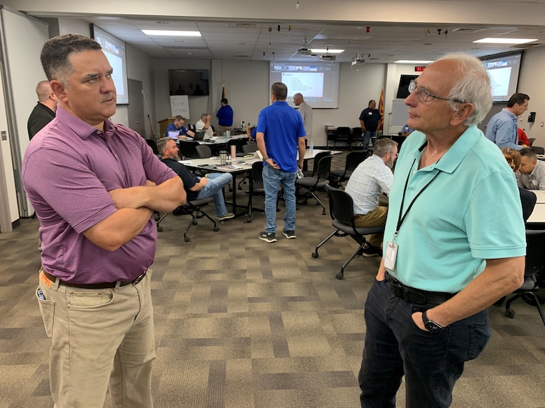 U.S. Army Corp of Engineers Los Angeles District Dam Safety Program Manager Kyle Hayworth, left, and LA District Emergency Management Branch Chief David Kingston, right, discuss mutli-agency response efforts during a tabletop exercise Sept.18 in Yuma, Arizona. Local, state, federal and nonfederal agencies practiced several scenarios focused on emergency response operations at Painted Rock Dam.