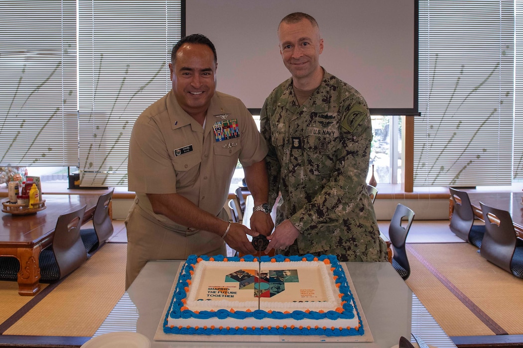 Command Master Chief Dennis Hunt, right, and Chief Warrant Officer Jesus Chavez, administration officer for Commander, Fleet Activities Yokosuka (CFAY), cut the ceremonial cake during a Hispanic Heritage Month luncheon at the installation’s Commodore Matthew C. Perry General Mess, Sept. 24, 2024.