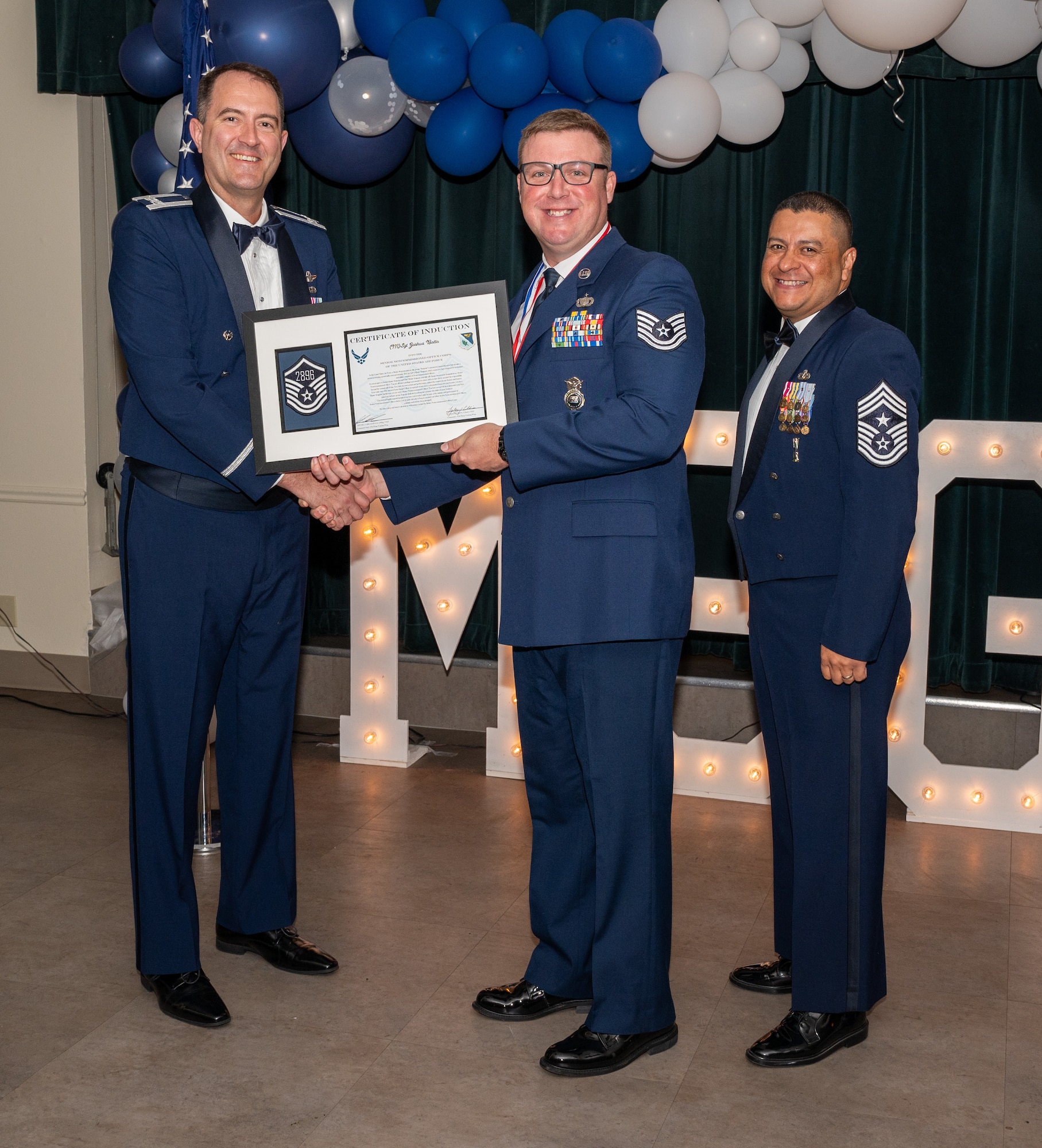 U.S. Air Force (M)Sgt Joshua Botto, 47th Security Forces Squadron accepts the certificate of induction during the senior non-commissioned officer (SNCO) induction ceremony at Laughlin Air Force Base, Texas, Sept. 27, 2024. The induction ceremony brings Airmen together to celebrate the achievement of entering the realm of senior enlisted leaders, as an SNCO they are expected to continue achieving the current and future Air Force vision with energy and strength. (U.S. Air Force photo by Staff Sgt. Nicholas Larsen)