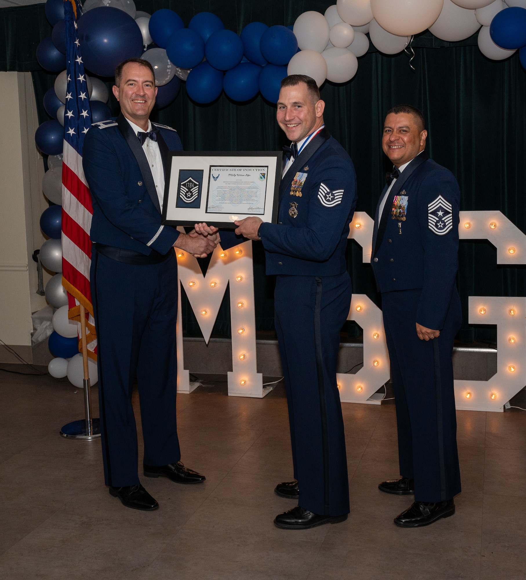 U.S. Air Force (M)Sgt Willian Slifer, 47th Security Forces Squadron accepts the certificate of induction during the senior non-commissioned officer induction ceremony at Laughlin Air Force Base, Texas, Sept. 27, 2024. The induction ceremony brings Airmen together to celebrate the achievement of entering the realm of senior enlisted leaders, as an SNCO they are expected to continue achieving the current and future Air Force vision with energy and strength. (U.S. Air Force photo by Staff Sgt. Nicholas Larsen)