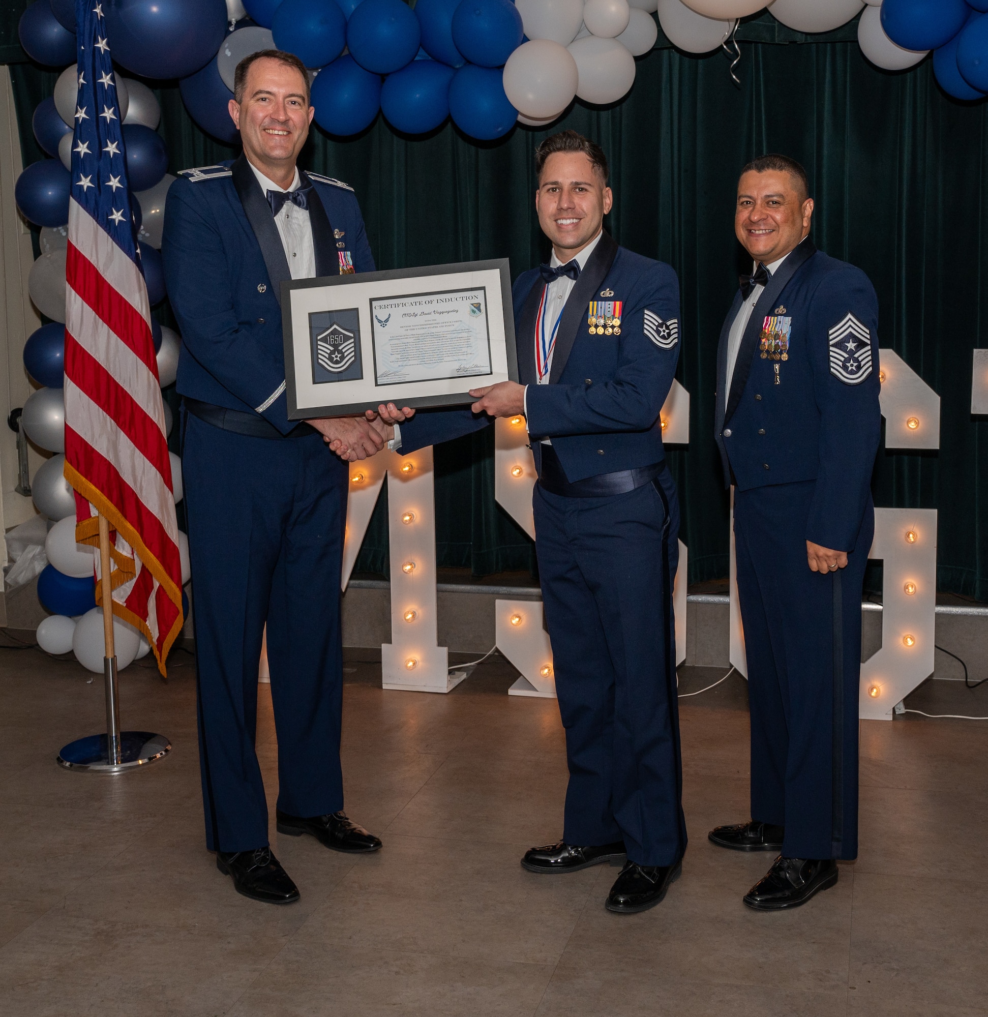 U.S. Air Force (M)Sgt David Vazquez Velez, 47th Operations Support Squadron, accepts the certificate of induction during the senior non-commissioned officer (SNCO) induction ceremony at Laughlin Air Force Base, Texas, Sept. 27, 2024. The induction ceremony brings Airmen together to celebrate the achievement of entering the realm of senior enlisted leaders, as an SNCO they are expected to continue achieving the current and future Air Force vision with energy and strength. (U.S. Air Force photo by Staff Sgt. Nicholas Larsen)