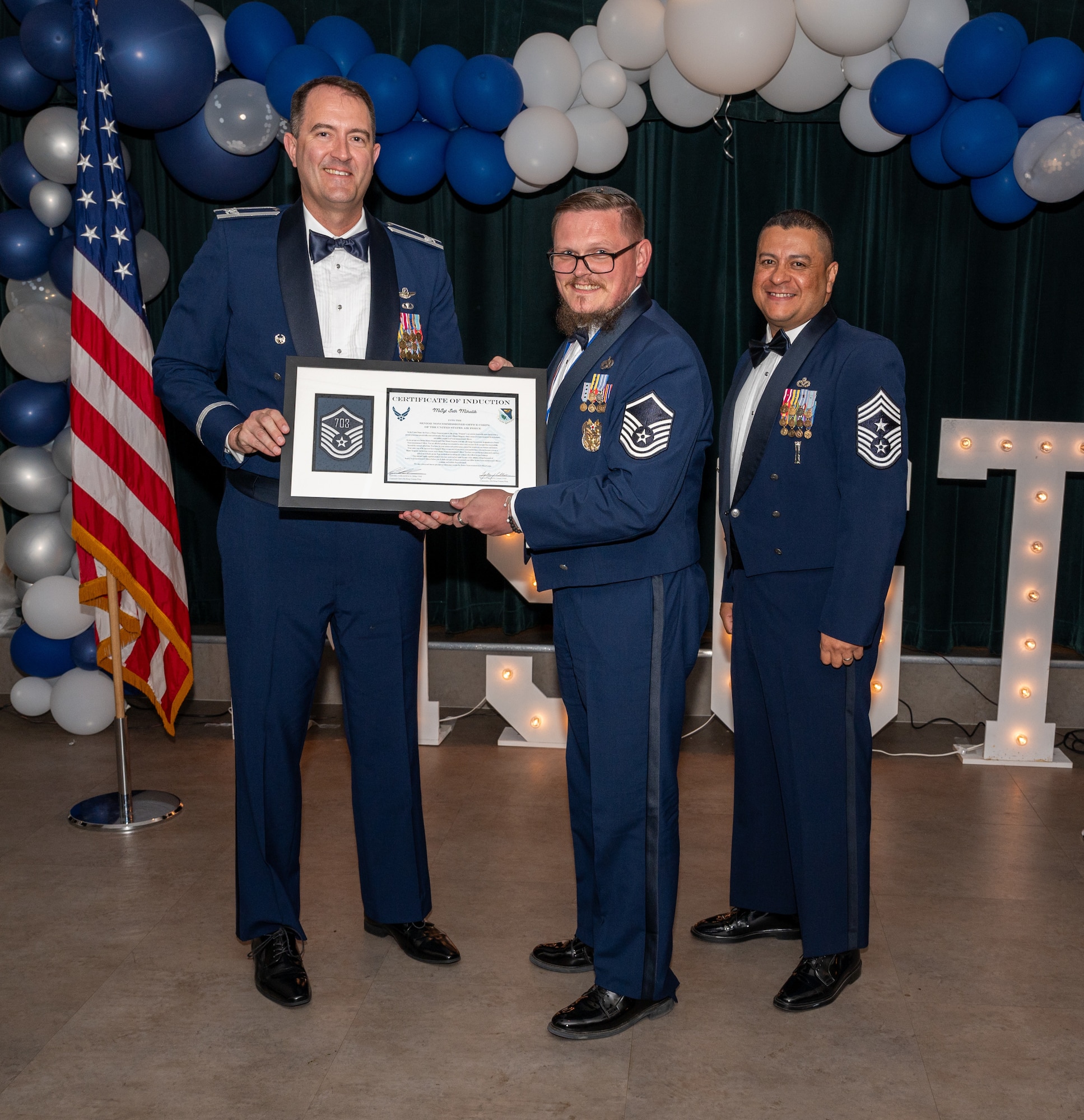 U.S. Air Force MSgt Seth Mihalik, 47th Inspector General’s Office, accepts the certificate of induction during the senior non-commissioned officer (SNCO) induction ceremony at Laughlin Air Force Base, Texas, Sept. 27, 2024. The induction ceremony brings Airmen together to celebrate the achievement of entering the realm of senior enlisted leaders, as an SNCO they are expected to continue achieving the current and future Air Force vision with energy and strength. (U.S. Air Force photo by Staff Sgt. Nicholas Larsen)