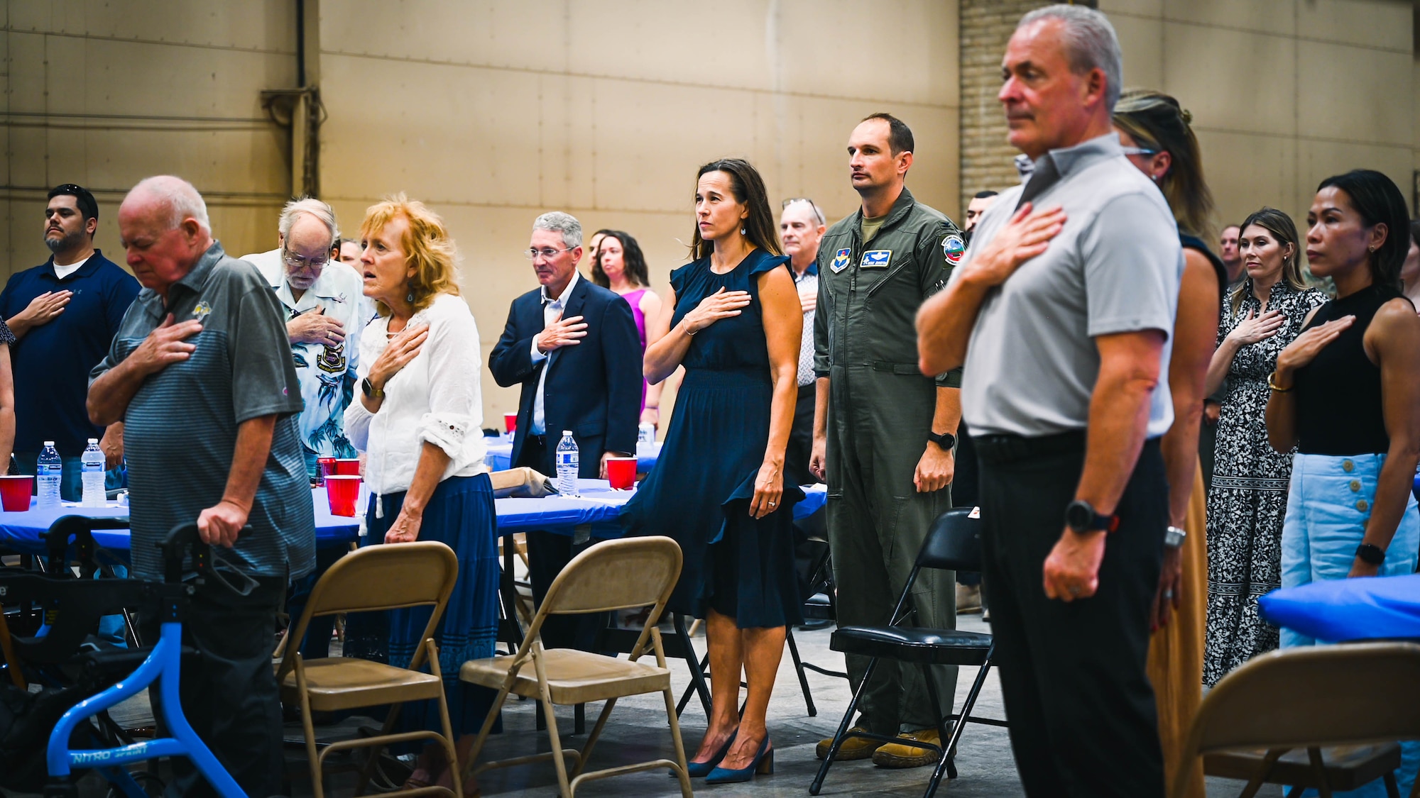 Luke Air Force Base leadership, family members and community members stand for the playing of the National Anthem during the final 309th Fighter Squadron graduation for F-16 Fighting Falcon pilots.