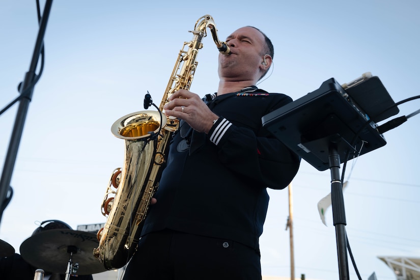 Sailor plays saxophone during a concert.