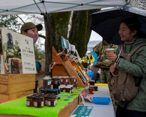 A vendor sells honey to local community members.